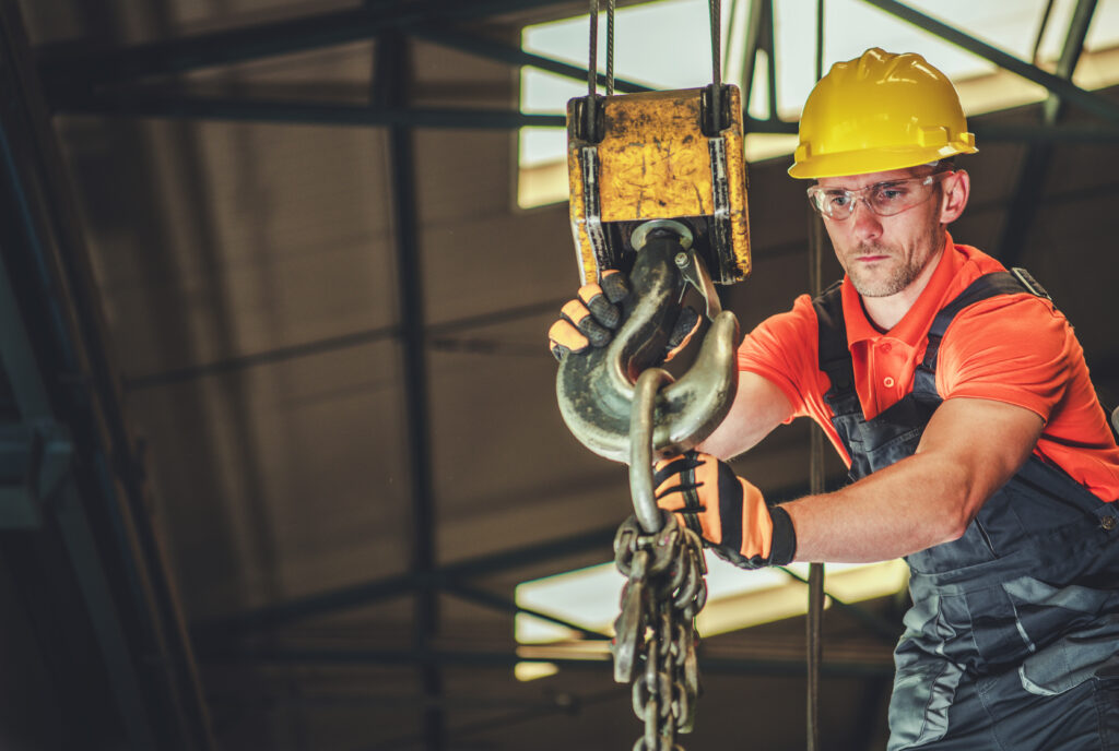 Professional construction worker loading an overhead crane