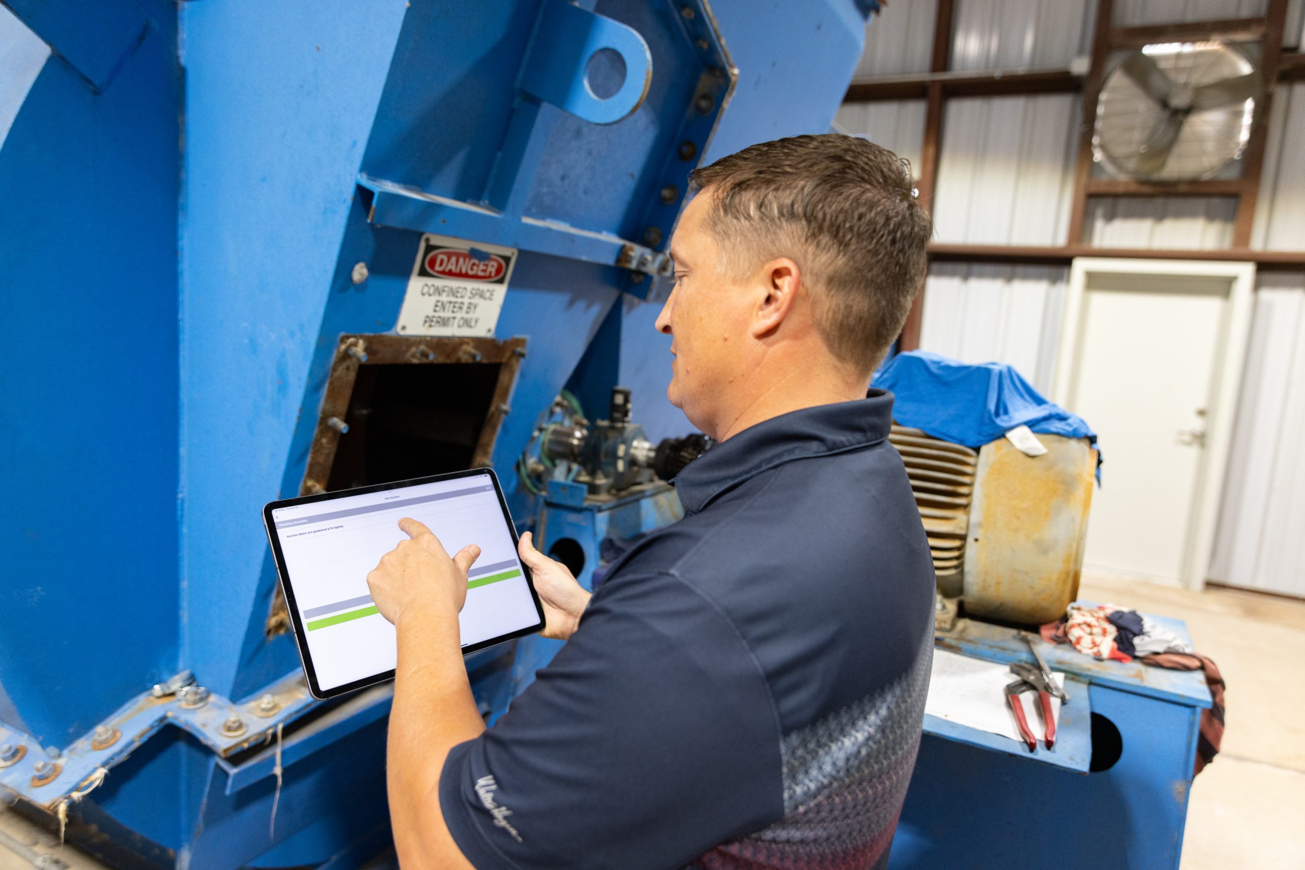 Manager walking through industrial plant with an iPad