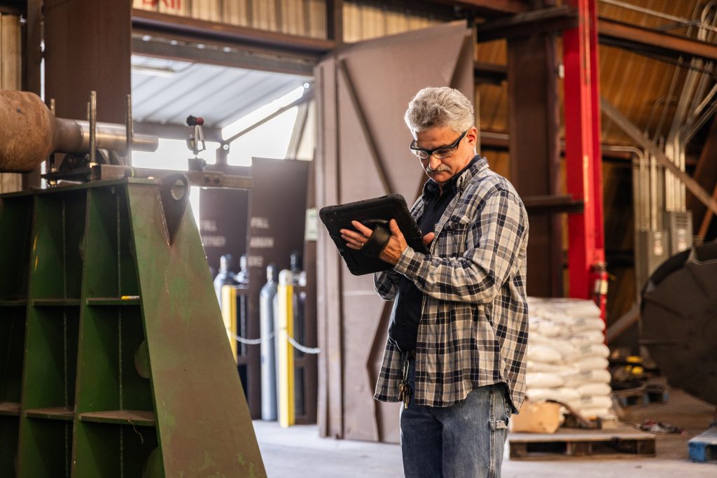 Field crew in industrial warehouse using crewOS integrated platform to improve efficiency