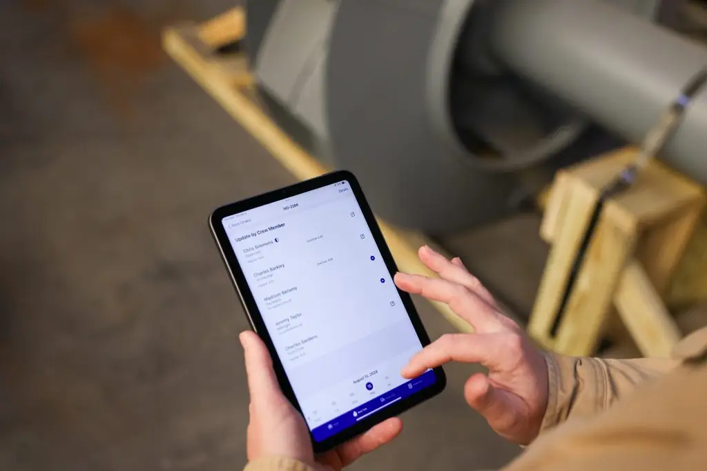 Industrial field worker using crewOS app in a manufacturing plant
