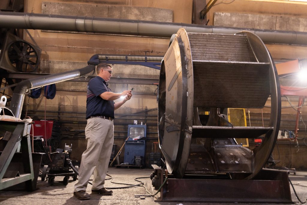 Equipment tracking in industrial field service - field worker inspecting a piece of equipment