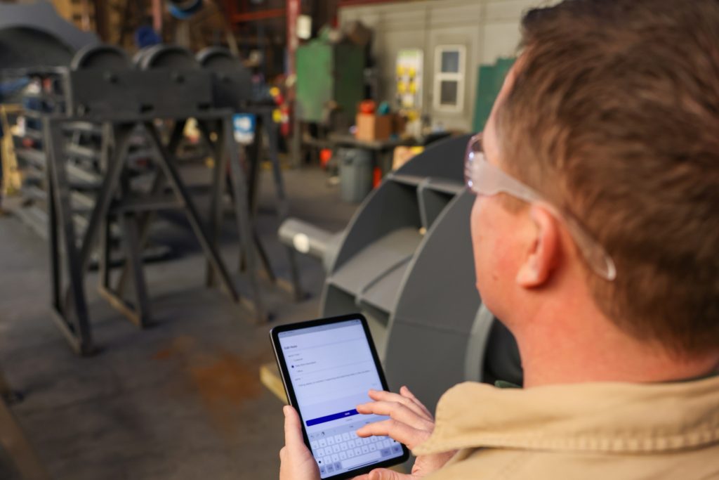 change order management in industrial field service - a tablet in the work place with the crewOS app open