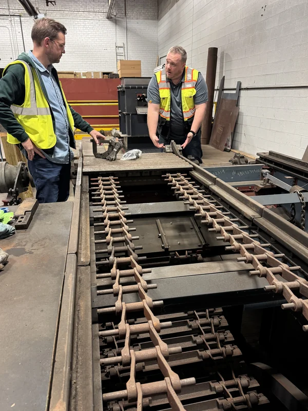 Jarrod Glasgow on site with a customer's team, reviewing equipment on the shop floor